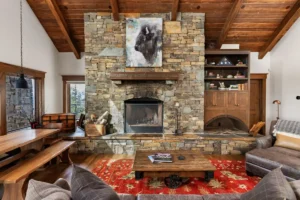 A stone fireplace anchors a traditional lodge home in North Idaho built by Smithwright.