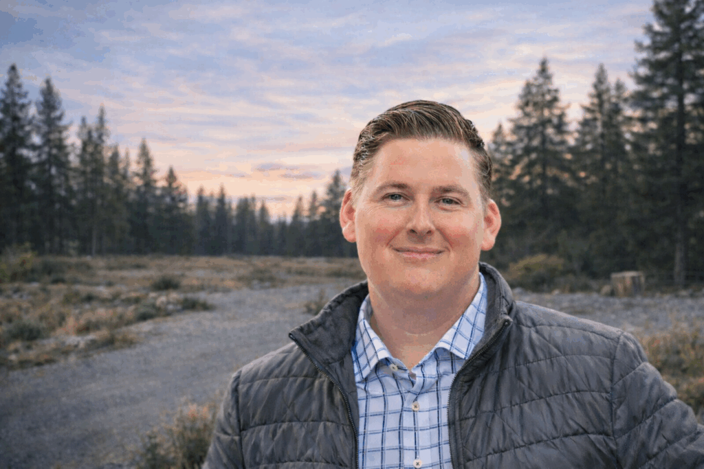 Jason Collins, CEO of Smithwright, photographed outdoors in North Idaho, with a background in structural engineering and high-end custom home design.