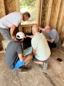 Doug Smith, founder of Smithwright, collaborating with architects and trades on site to review design details during high-end custom home construction in North Idaho.