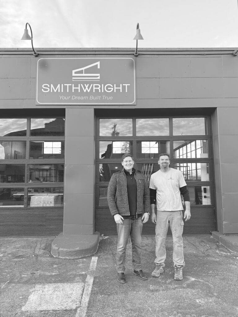 Smithwright owners Jason Collins and Doug Smith standing in front of the firm’s headquarters at 120 Cedar Street in downtown Sandpoint during renovation.