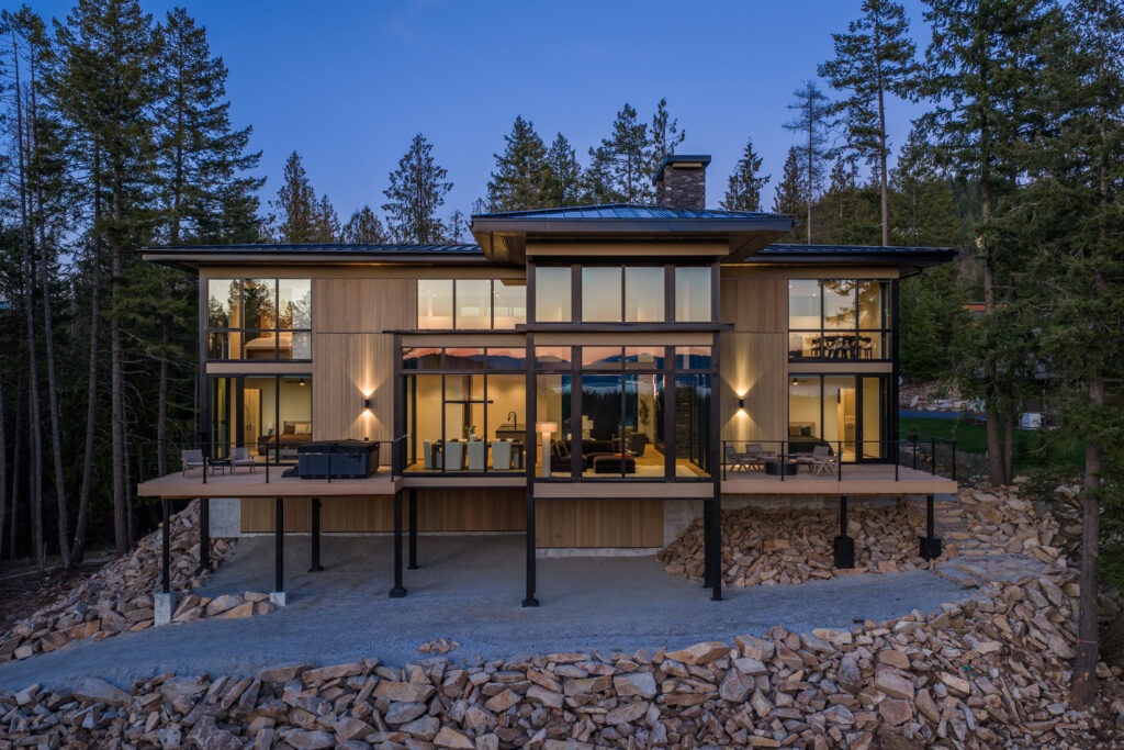 Modern luxury home in Sandpoint Idaho at The Idaho Club with floor-to-ceiling windows and views of Lake Pend Oreille and Schweitzer Mountain
