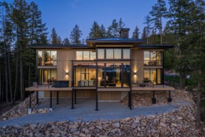 Modern luxury home in Sandpoint Idaho at The Idaho Club with floor-to-ceiling windows and views of Lake Pend Oreille and Schweitzer Mountain